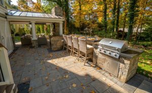 Patio with interlocking stones and grill enclosure