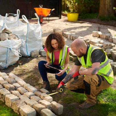 Contractor measuring landscaping materials, including bricks